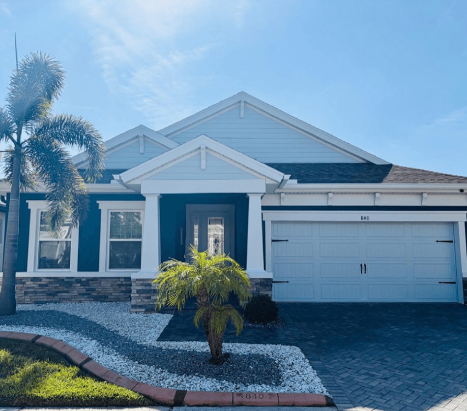 Home after deep navy exterior painting with white trim, Sarasota FL
