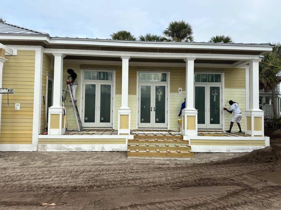 MJD Coastal Services painter at work on a home exterior in Sarasota, FL